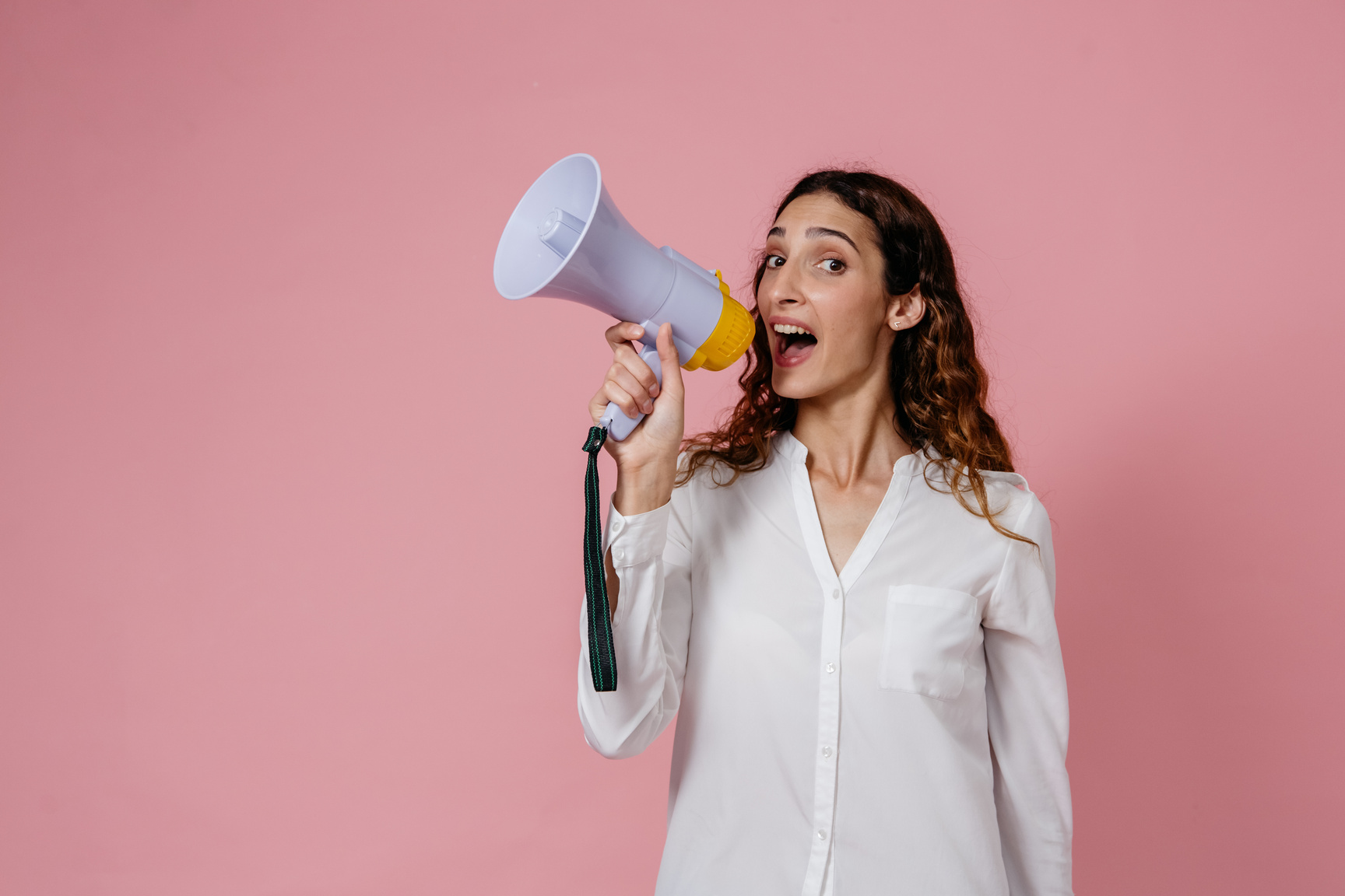 Woman in White Button Up Long Sleeve Shirt Holding Microphone